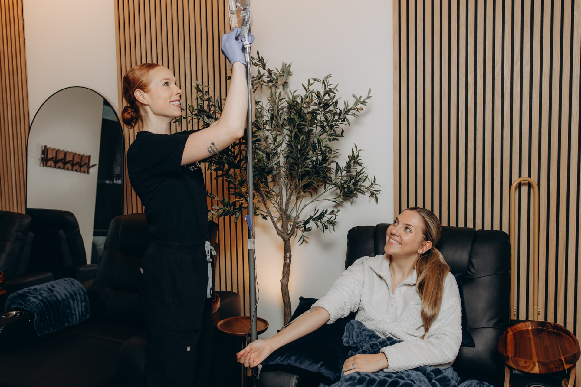 Licensed nurse administering IV therapy to a patient at Arctic Elevation